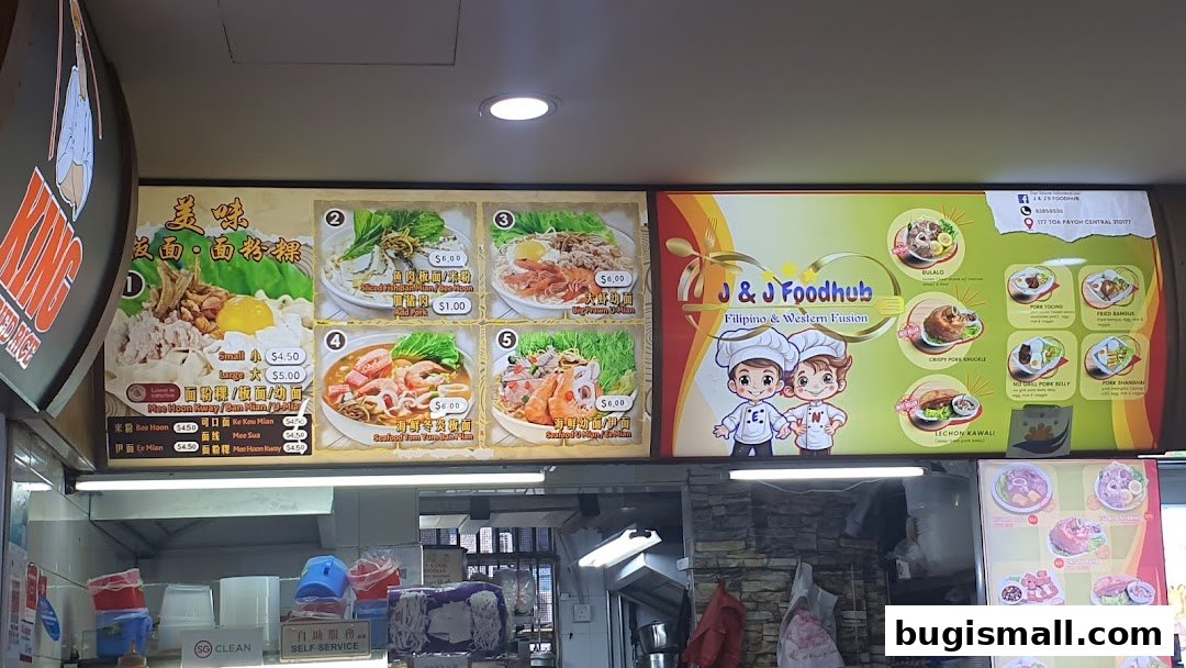 A menu board displaying various noodle dishes and Filipino/Western fusion food items.