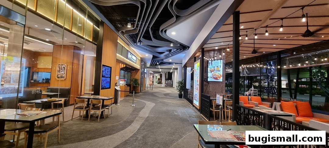 Exterior view of Xin Wang Hong Kong Café with outdoor seating and illuminated signage.