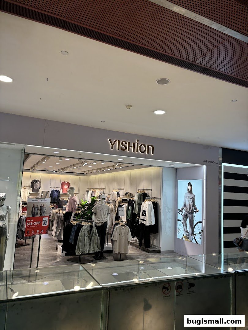The YISHION store in Bugis, showcasing trendy apparel on mannequins and racks.