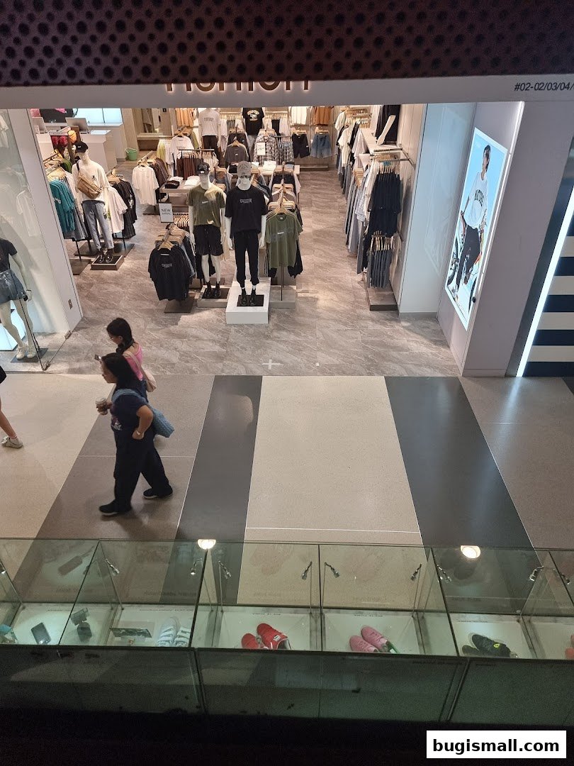 View of a YISHION clothing store interior with mannequins and apparel displayed.