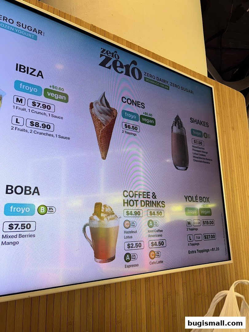A digital menu board displaying various frozen yogurt, shakes, coffee, and boba options.