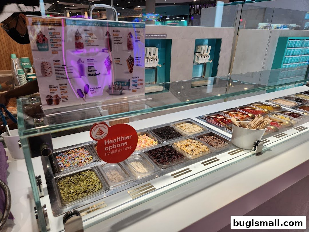A display of frozen yogurt flavors and toppings at Yolé Bugis.
