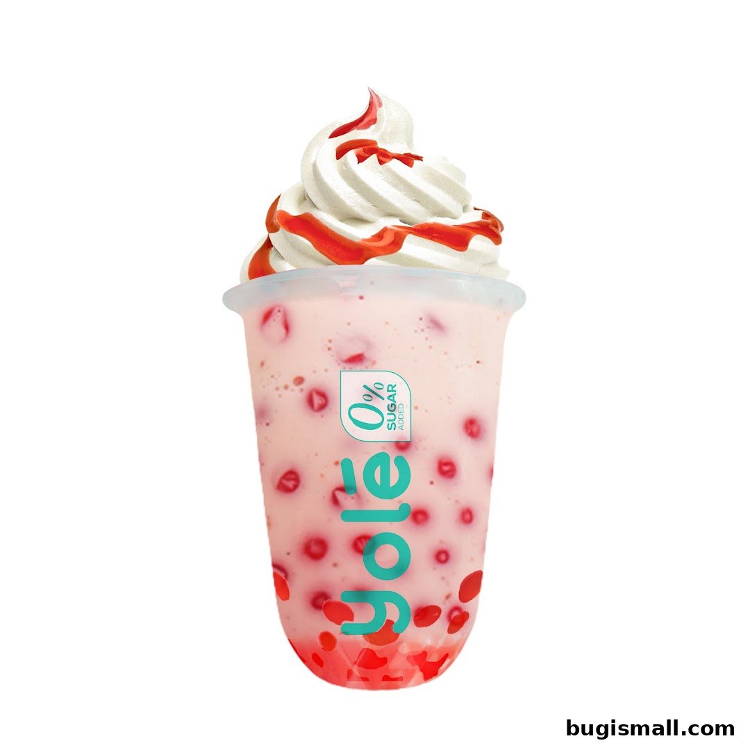 A strawberry yogurt drink with whipped cream and strawberry syrup from Yolé.