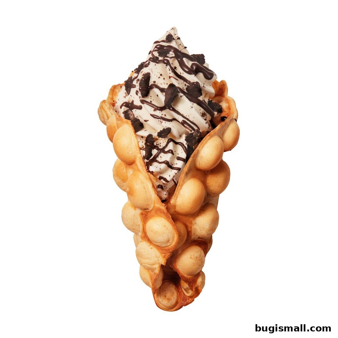 A delicious bubble waffle cone filled with soft-serve ice cream, chocolate drizzle, and cookie crumbles.