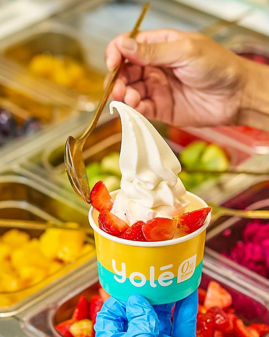 Yole soft serve ice cream with strawberries in a branded cup